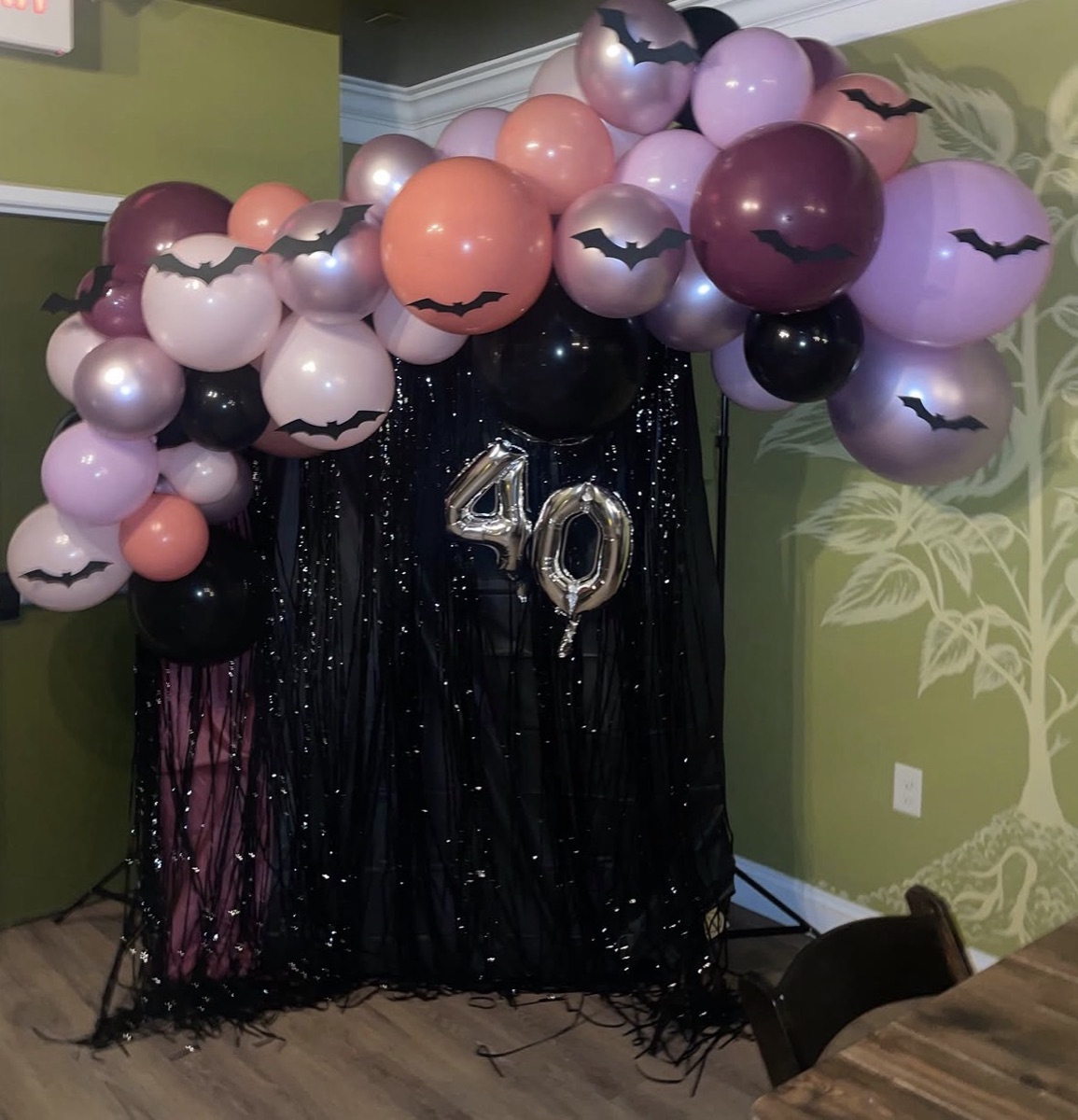 40th birthday Halloween theme balloon arch with bats, purple, orange and black balloons
